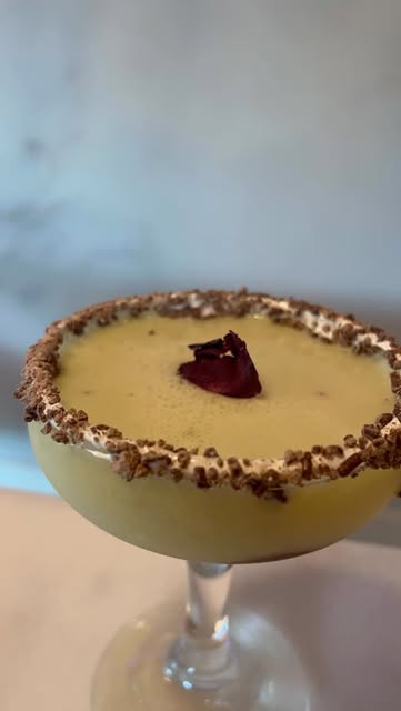 Creamy martini with a rose petal and chocolate rim