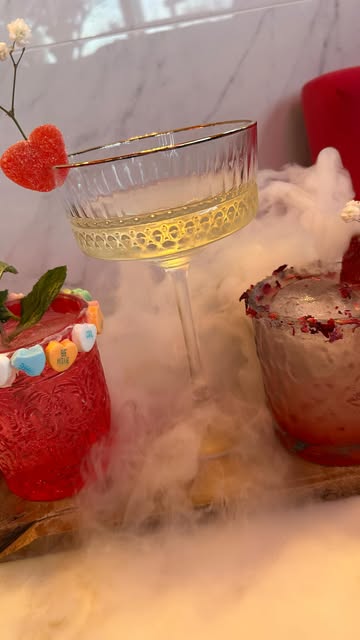 Coupe cocktail with heart garnish over dry-ice fog